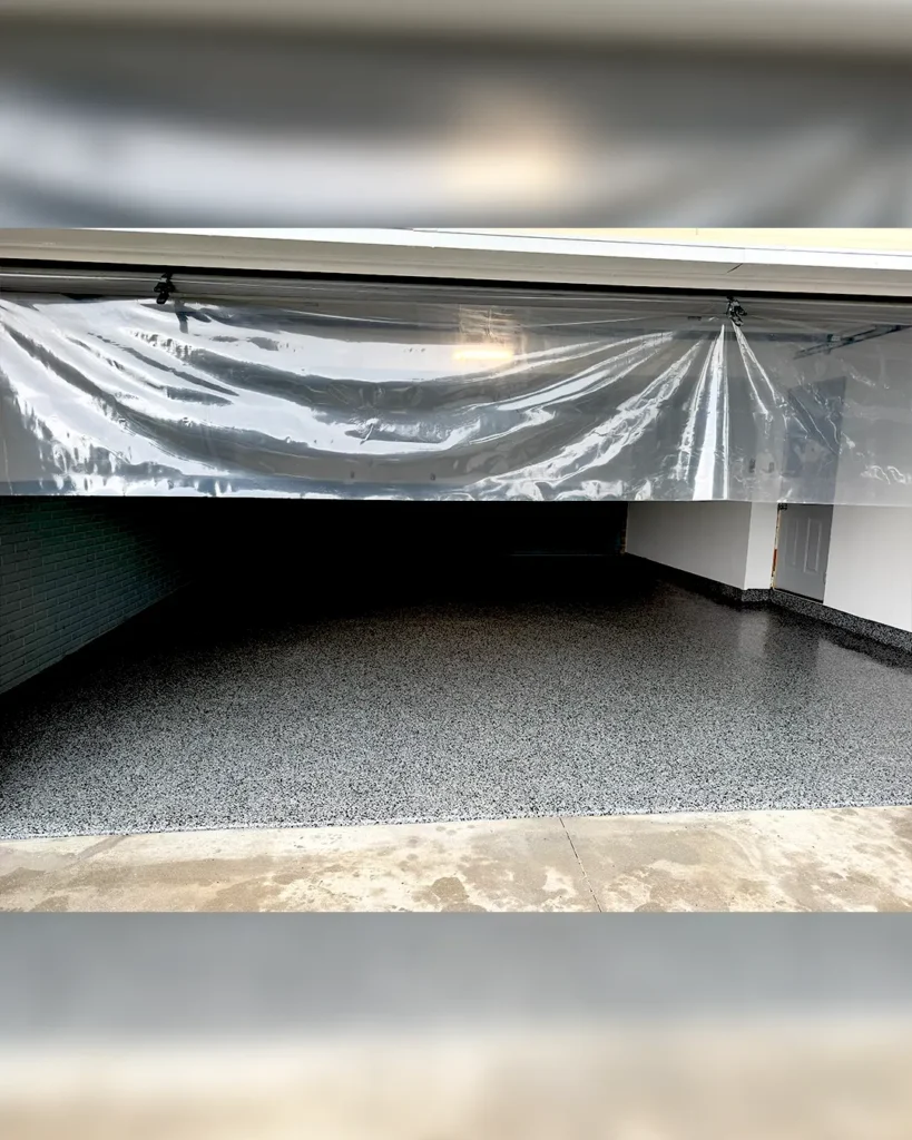 Finished flake epoxy garage floor viewed from the entrance in Iowa